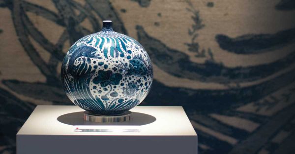 Vase with Fish and Aquatic Plants Motif by Yuki Hayama shown against 'Sea Tangle' by Joseph Carini Carpets. - The Ruggist | Image courtesy of Joseph Carini Carpets