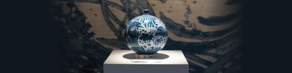 Vase with Fish and Aquatic Plants Motif by Yuki Hayama shown against 'Sea Tangle' by Joseph Carini Carpets. - The Ruggist | Image courtesy of Joseph Carini Carpets