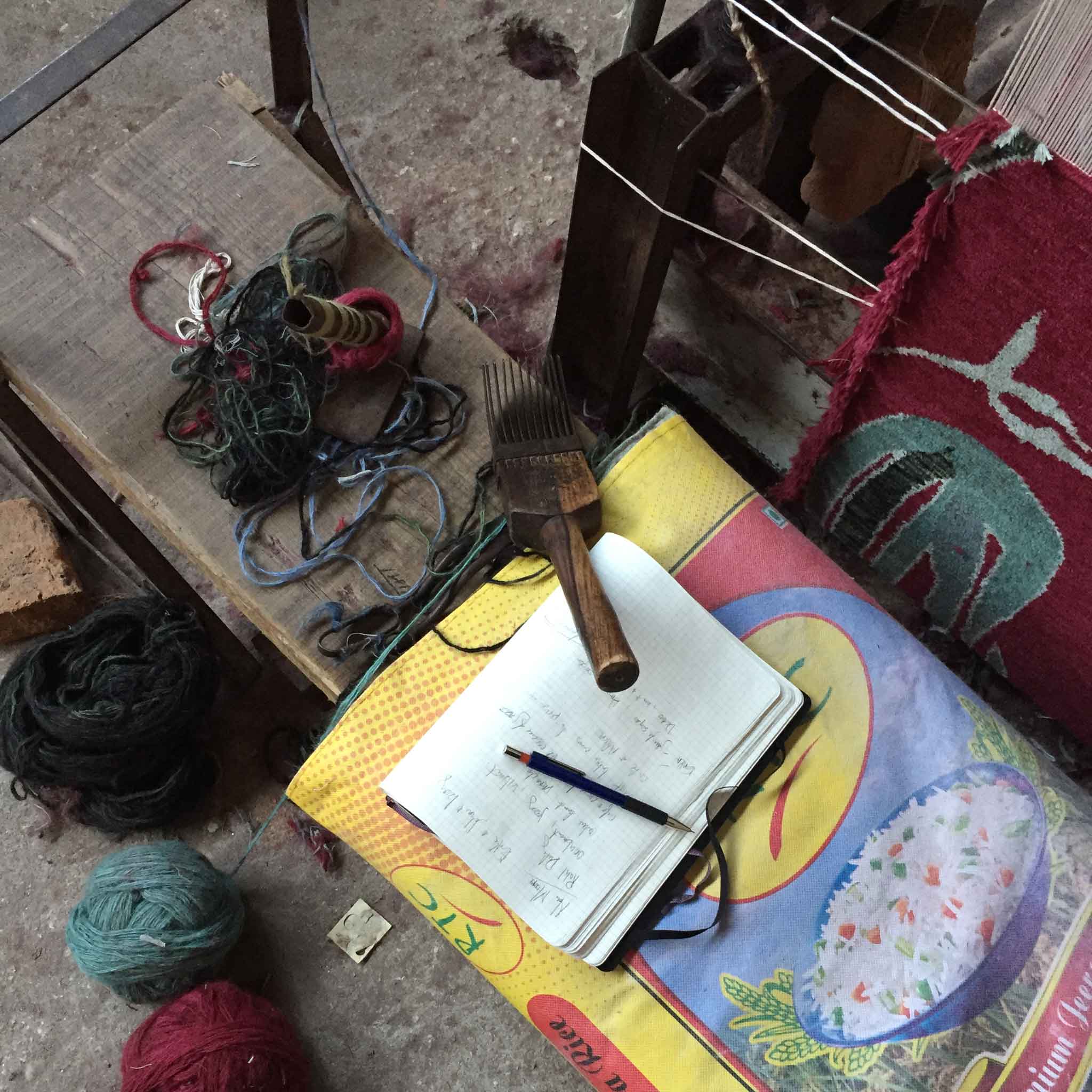 An impromptu and non-staged still life in which writer meets weaver. 'Camara' in colour 'Oxblood' by New Moon is visible on loom at the right. | Image courtesy of The Ruggist.
