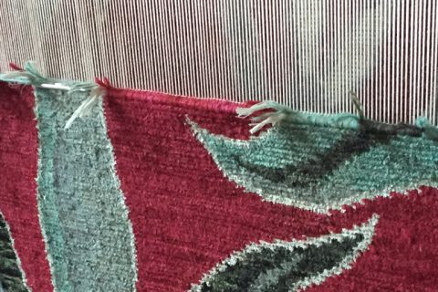 'Camara' in colour 'Oxblood' by New Moon shown on loom in Nepal. | Image courtesy of The Ruggist.
