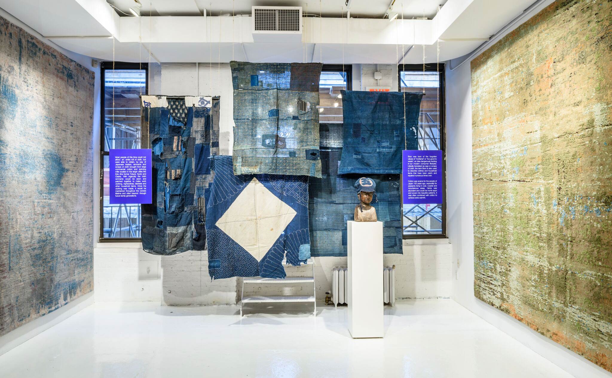 Traditional Boro textile garments (on loan to Jan Kath from a private collection) displayed in juxtaposition to the firm's contemporary carpet collection by the same name. | Image courtesy of Jan Kath.