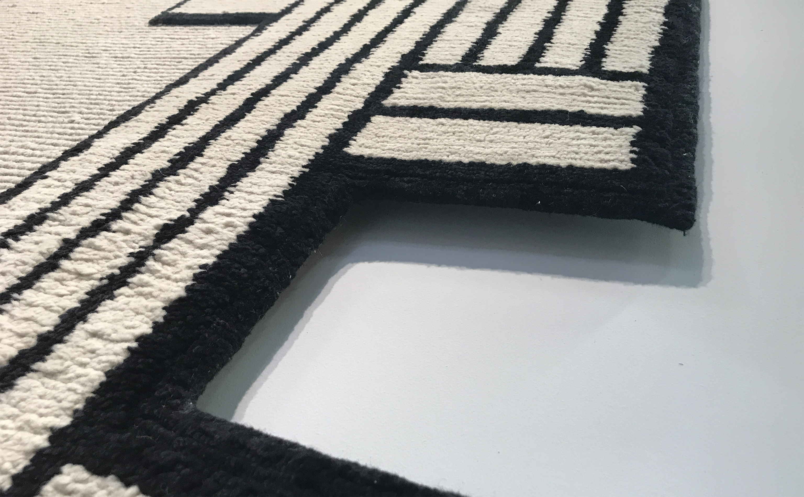 'Asmara' by Federico Pepe for cc-tapis, shown in detail, as seen during IMM Cologne. The design is named after the capital of Eritrea, much of which was built in the colonial Italian era just prior to World War II. It is considered a premier example of a modernist Art Deco city. | Image by The Ruggist.