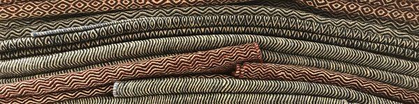 A stack of folded Iranian flatweaves as seen at Edelgrund during Domotex 2019 | Photograph by The Ruggist.