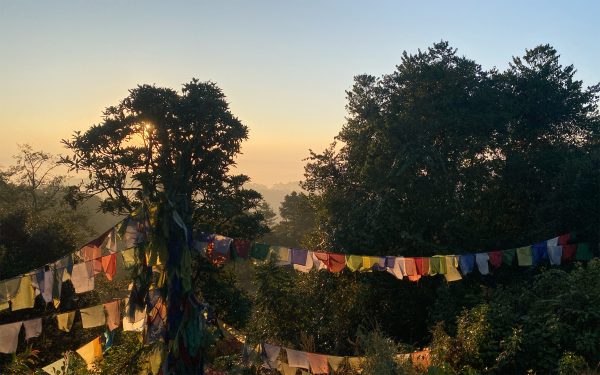 Tibetan Prayer Flags as seen at sunrise in Nagarkot on the rim of the Kathmandu Valley. The weekend of 'Open Studio' features tours of UNESCO World Heritage Sites as well as excursions to notable sites, all intended to foster a deeper understanding of Nepal and its people.
